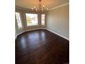 Formal dining room featuring dark wood floors, chandelier, and bright windows at 11506 Greenbriar Ln, Parker, CO 80138