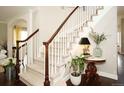 Elegant staircase with white railings and wooden handrail adds a touch of sophistication to the home's interior at 11506 Greenbriar Ln, Parker, CO 80138