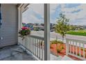 Inviting front porch with white railing, landscaping and neighborhood views at 4505 Cholla Trl, Castle Rock, CO 80104