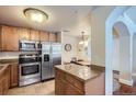 Updated kitchen with stainless steel appliances and granite countertops on a kitchen island at 4500 Baseline Rd # 3101, Boulder, CO 80303