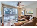 Cozy living room with a ceiling fan, large sliding doors, and comfortable seating at 4500 Baseline Rd # 3101, Boulder, CO 80303
