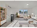 Bright living room with modern decor, sleek furniture, and lots of natural light at 12238 Monroe Dr, Thornton, CO 80241