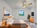 Cozy staged bedroom featuring a neutral color scheme, ceiling fan, and view to the outdoors at 12238 Monroe Dr, Thornton, CO 80241