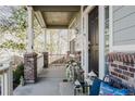 Welcoming covered front porch with comfortable seating and decorative details at 12490 Kearney Cir, Thornton, CO 80602