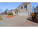 Inviting two-story home with a cozy front porch and well-maintained landscaping at 20781 E 48Th Pl, Denver, CO 80249