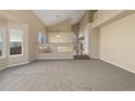 Bright living room featuring vaulted ceilings, neutral carpet, and expansive windows for natural light at 20781 E 48Th Pl, Denver, CO 80249