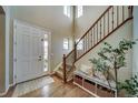 Inviting entryway with wood floors, lots of natural light, and an attractive staircase at 21682 E Stroll Ave, Parker, CO 80138