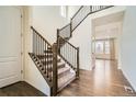 Elegant staircase with dark wood and black iron railings, leading to the second floor at 9544 Pitkin St, Commerce City, CO 80022