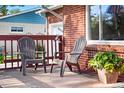 Inviting front porch with comfortable seating, perfect for relaxing and enjoying the outdoors at 6506 Lee St, Arvada, CO 80004