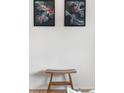 Stylish home decor featuring artistic paintings and a unique wooden bench, adding a touch of elegance at 6506 Lee St, Arvada, CO 80004