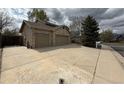 Spacious three-car garage with a wide driveway, perfect for ample parking space at 13031 Dexter St, Thornton, CO 80241
