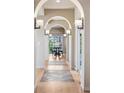 Beautiful hallway with archways leading to an outside sitting area with a view at 5192 Sedona Dr, Parker, CO 80134
