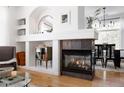 Inviting living room with a fireplace, built-in shelves, and an open layout, perfect for entertaining and relaxation at 4500 E Louisiana Ave, Denver, CO 80246