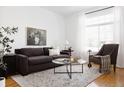 Stylish living room with comfortable seating, a large window with natural light, and a neutral color palette for relaxation at 4500 E Louisiana Ave, Denver, CO 80246