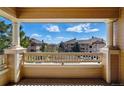 Balcony view overlooking well-maintained buildings and distant scenery on a bright, sunny day at 9557 W San Juan Cir # 306, Littleton, CO 80128