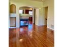 Inviting living room with a fireplace, gleaming hardwood floors, and plenty of natural light at 1368 Royal Troon Dr, Castle Rock, CO 80104