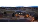 Aerial view of a residential home with a three-car garage and a golf course view at 7965 S Titus Ct, Aurora, CO 80016