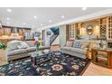 Spacious living room features hardwood floors and built-in wet bar at 18971 Shadowood Dr, Monument, CO 80132