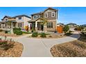 Inviting two-story home showcasing a landscaped front yard, stone accents, and a concrete walkway at 6833 Longpark Dr, Parker, CO 80138