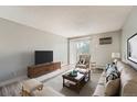 Bright living room with a comfortable couch, a large window, and stylish decor at 451 Golden Cir # 210, Golden, CO 80401