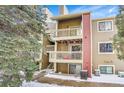 Building exterior showcasing a balcony and snow-covered ground at 10872 W Evans Ave # 2E, Lakewood, CO 80227