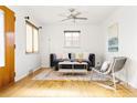 Bright and modern living room with hardwood floors, a ceiling fan and natural light at 2801 N Garfield St, Denver, CO 80205
