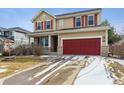 Charming home featuring a red garage door, complementing the red shutters at 13850 Meadowbrook Dr, Broomfield, CO 80020