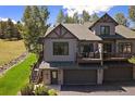 Charming home features an upper deck, a two-car garage, and wooden staircase at 31028 Big Bear Dr, Evergreen, CO 80439