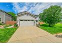 Two-story home with a two-car garage, well maintained lawn and landscaping in a suburban neighborhood at 215 Mcafee Cir, Erie, CO 80516