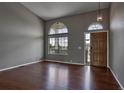 Bright entryway with hardwood floors, high ceilings, arched windows, and a stylish chandelier at 245 Homestead Way, Brighton, CO 80601