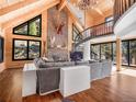 Stunning living room with a stone fireplace and spiral staircase at 24 Pine Valley Rd, Evergreen, CO 80439
