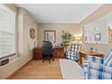 Bright home office featuring hardwood floors, neutral walls, and comfortable seating at 1051 Bramblewood Dr, Castle Pines, CO 80108