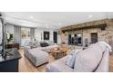 Inviting living room with a cozy fireplace, plush seating, and natural light at 8451 London Ln, Conifer, CO 80433