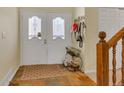 Bright foyer with a tiled floor, double doors, and a staircase leading to the upper level of the home at 2804 S Heather Gardens Way # A, Aurora, CO 80014