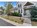 Inviting front entrance with bay window, lush landscaping, and a stone walkway at 2032 W Nantucket Ct, Littleton, CO 80120