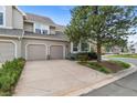Spacious two-car garage with a large driveway and mature landscaping at 2032 W Nantucket Ct, Littleton, CO 80120