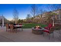 Stone firepit, outdoor dining, and a scenic backyard make for a great place to spend an evening at 2090 Bellavista St, Castle Rock, CO 80109