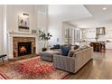 Bright living room features hardwood floors, fireplace, and flows into the modern kitchen at 2090 Bellavista St, Castle Rock, CO 80109