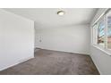 Living room featuring large window for natural light and neutral walls at 16622 E Asbury Ave, Aurora, CO 80013
