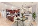 Open kitchen and dining area featuring an island and hardwood floors at 1630 N Clarkson St # 204, Denver, CO 80218