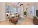 Bright living room with hardwood floors, large windows, and neutral decor at 1630 N Clarkson St # 204, Denver, CO 80218