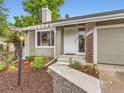 Inviting front yard with landscaped garden beds and walkway leading to the front door at 6378 S Emporia Cir, Englewood, CO 80111