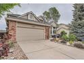 Inviting two-story home featuring a brick and siding exterior with lush landscaping at 19098 E Ida Dr, Aurora, CO 80015