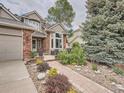 Charming two-story home with brick accents and a beautifully landscaped front yard with walkway at 19098 E Ida Dr, Aurora, CO 80015