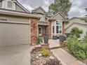 Charming two-story home with brick accents and a beautifully landscaped front yard with patio at 19098 E Ida Dr, Aurora, CO 80015