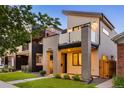 Modern two-story home with sleek architectural design and a neatly landscaped yard at 2060 Eliot St, Denver, CO 80211