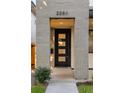 Modern front door with sidelights and gray brick surround at 2060 Eliot St, Denver, CO 80211