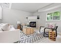 Spacious living room featuring a fireplace, comfortable seating, and a bright window view at 204 Maple St, Frederick, CO 80530