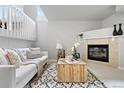Stylish living area with a cozy fireplace, modern furnishings, and ample natural light at 204 Maple St, Frederick, CO 80530