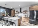 Modern kitchen with stainless steel appliances and large island at 3580 W 62Nd Pl, Denver, CO 80221